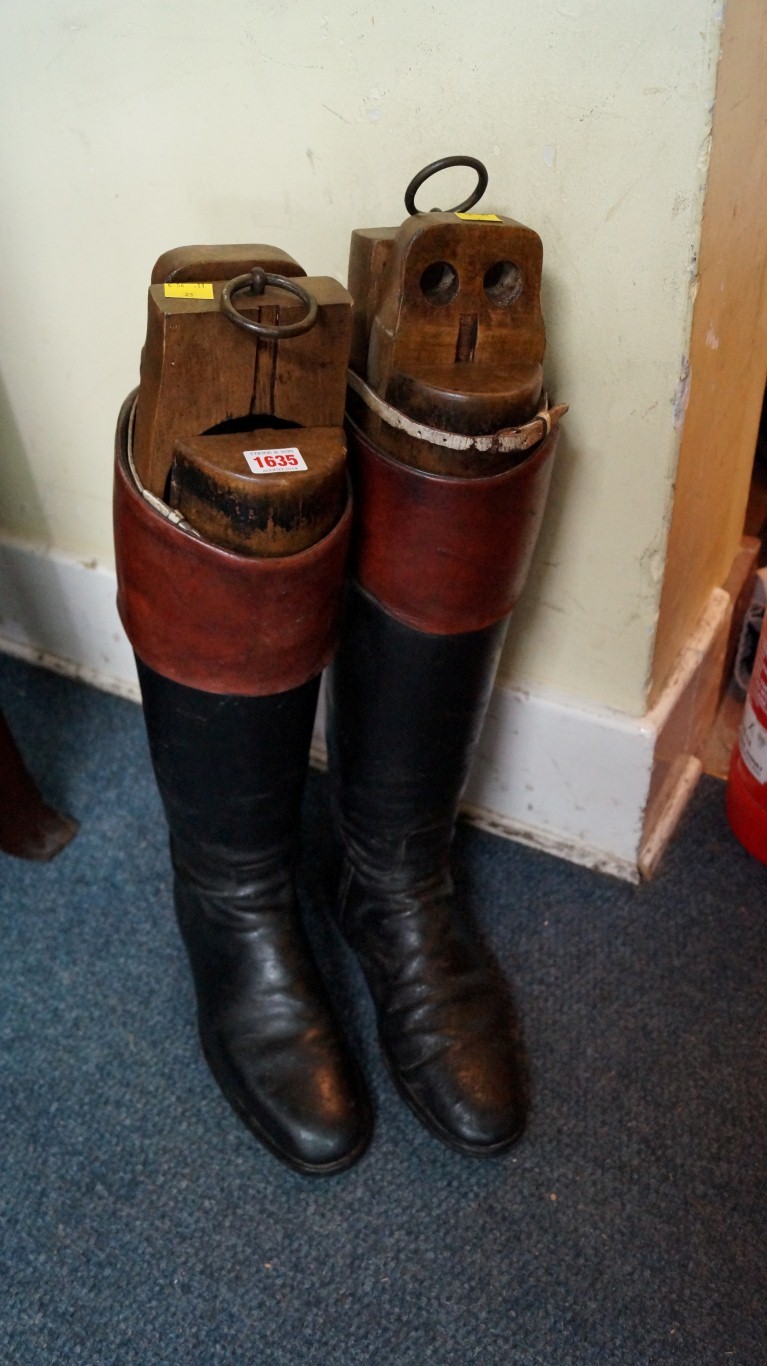 A pair of 19th century black leather riding boots, each with four section wooden tree.