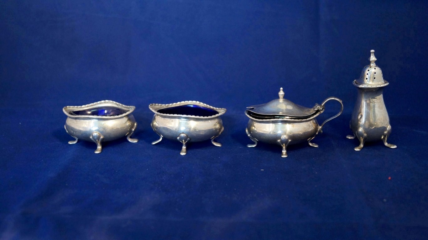 A silver four piece condiment set, by E.S.B, Birmingham 1916, 135g.   Condition Report:  Two of