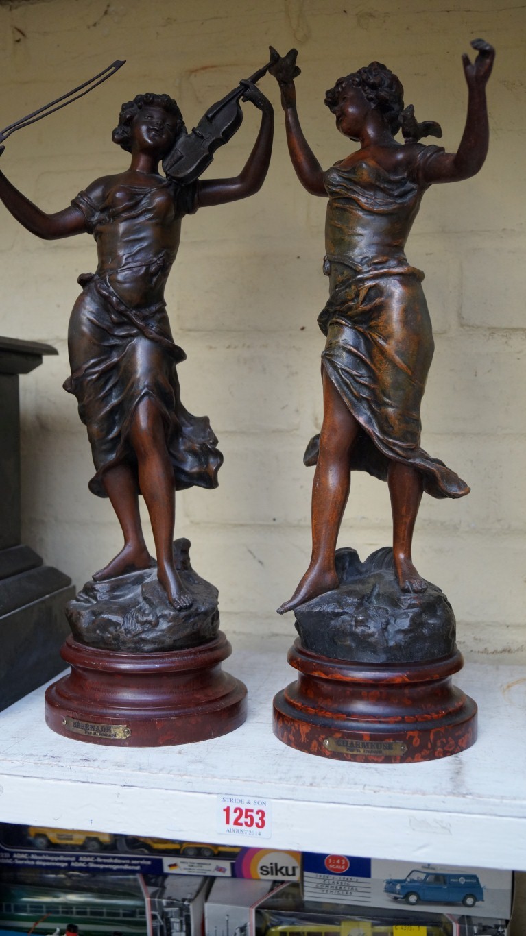 After R Richard, a pair of patinated spelter figures, each on a faux marble socle, total height