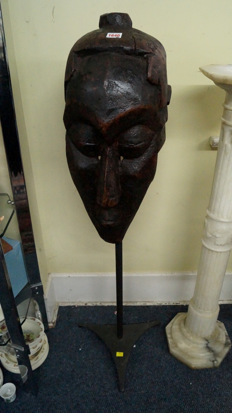 Ethnographia: a large carved wood tribal mask, on tripod stand. Condition Report: Measures
