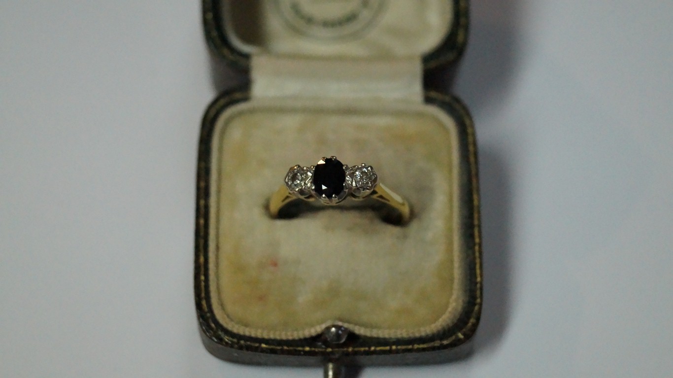 A gold diamond and sapphire three stone ring.