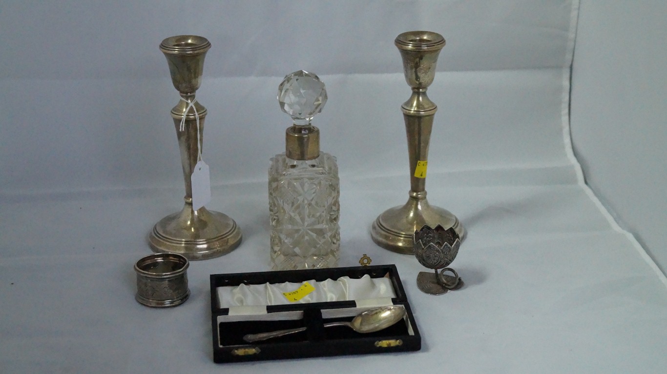 A pair of silver candlesticks; together