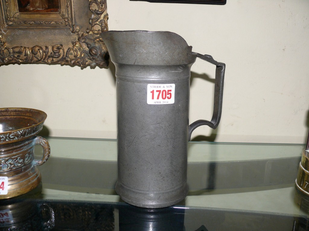 An 18th/19th century pewter jug, inscribed 'Schuties', 20.5cm high.