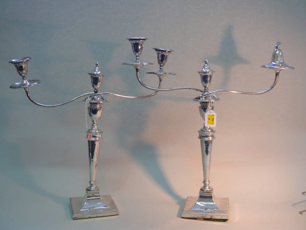 A pair of George III silver candlesticks, makers mark over stamped T D, Sheffield 1784, having