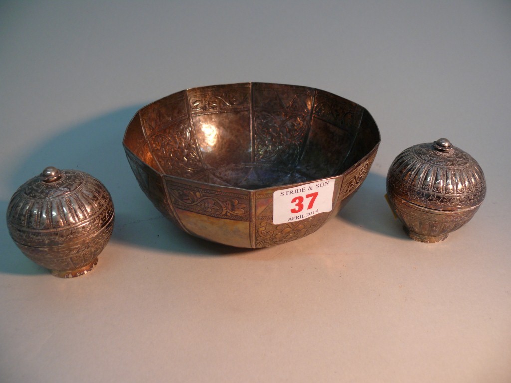 An Eastern white metal ten sided bowl; together with a pair of small white metal pots and