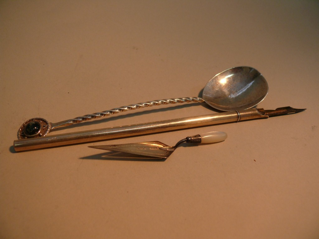 A silver pen; together with a metal spoon; and a silver and agate trowel shaped book mark or paper