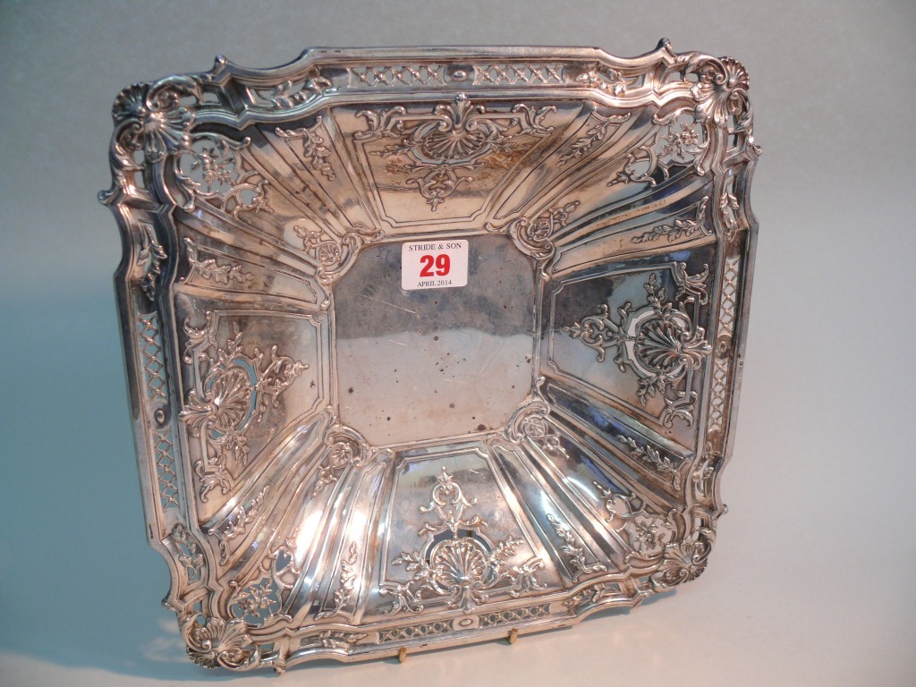 A continental white metal square fruit bowl, having pierced floral and scroll decoration, 27cm