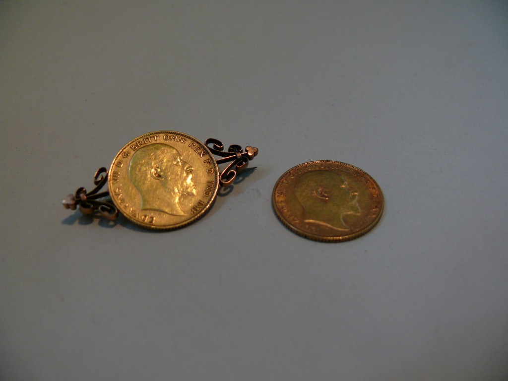 An Edward VII half sovereign, 1907; together with an Edward VII half sovereign, 1905, in brooch