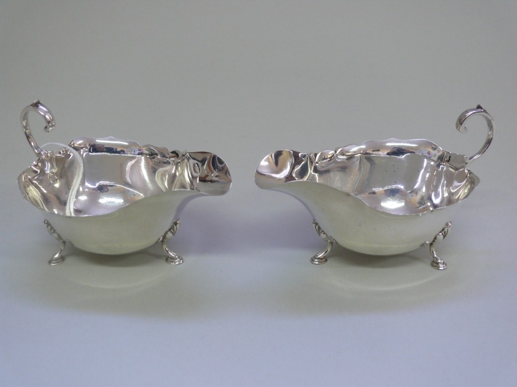 A pair of silver sauce boats, by Robert Pringle & Sons, Birmingham 1934, having crimped rims and