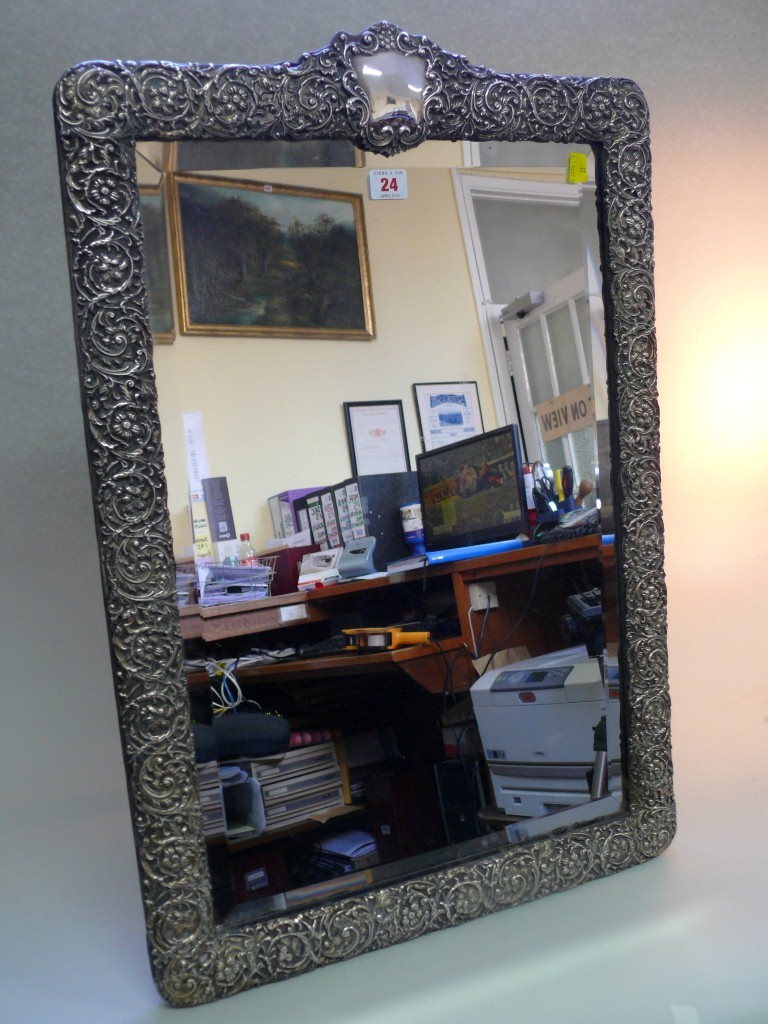 An Edwardian silver large easel back mirror, by H Matthews, Birmingham 1903, having floral scroll