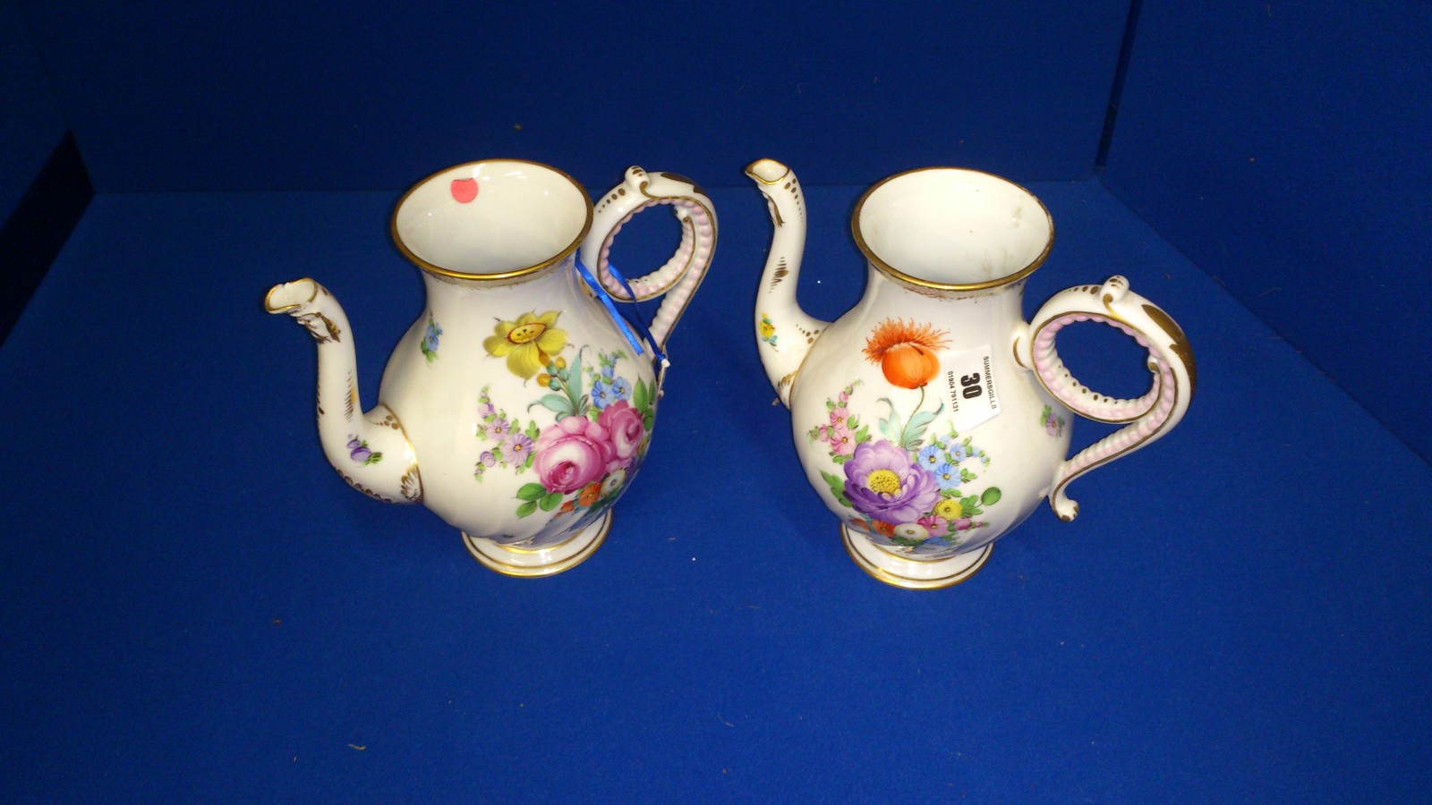 pair of coffee pots with flower decoration (damaged)