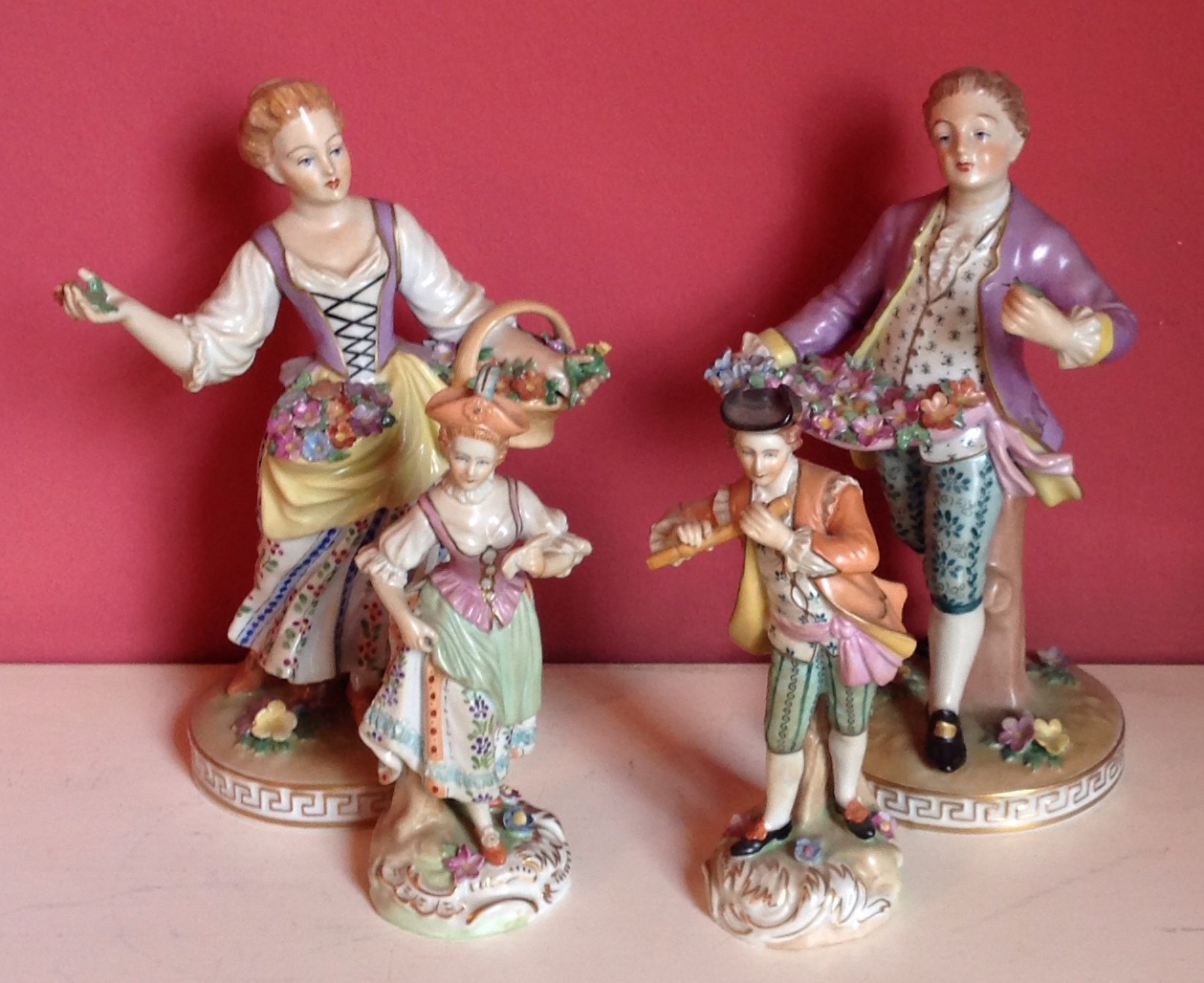 A PAIR OF DRESDEN FIGURES OF FLOWER SELLERS Along with another pair, musicians.