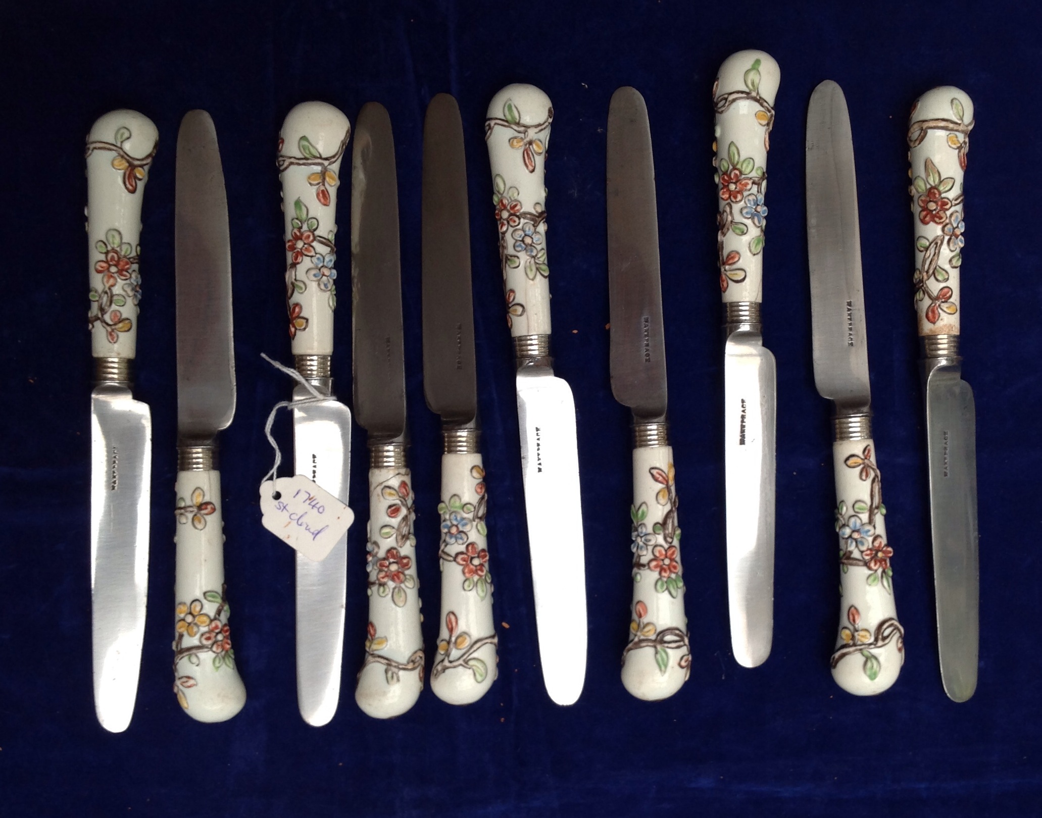 AN 18TH CENTURY FRENCH ST. CLOUD PORCELAIN HANDLED SET OF TEN KNIVES The pistol grip handles