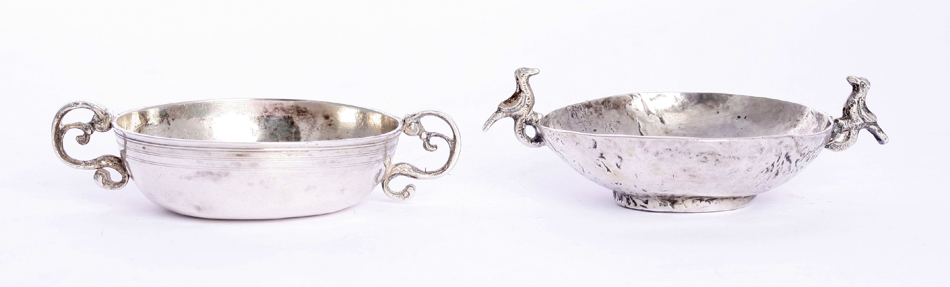 A two-handled silver wine taster,probably South American, 19th century, of shallow circular form