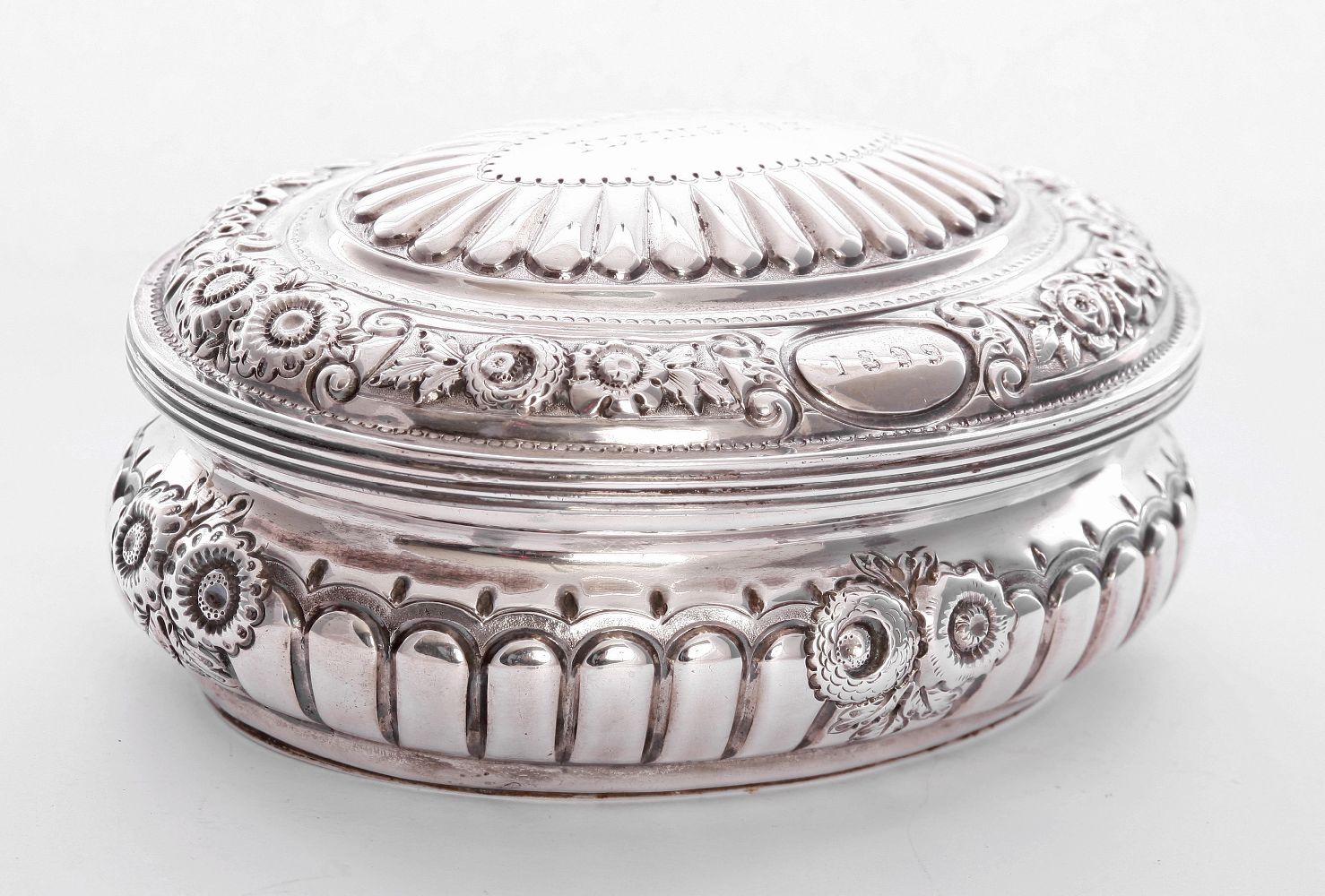 A Victorian silver box, by Carrington & Co., London 1898, of half fluted, compressed oval form,