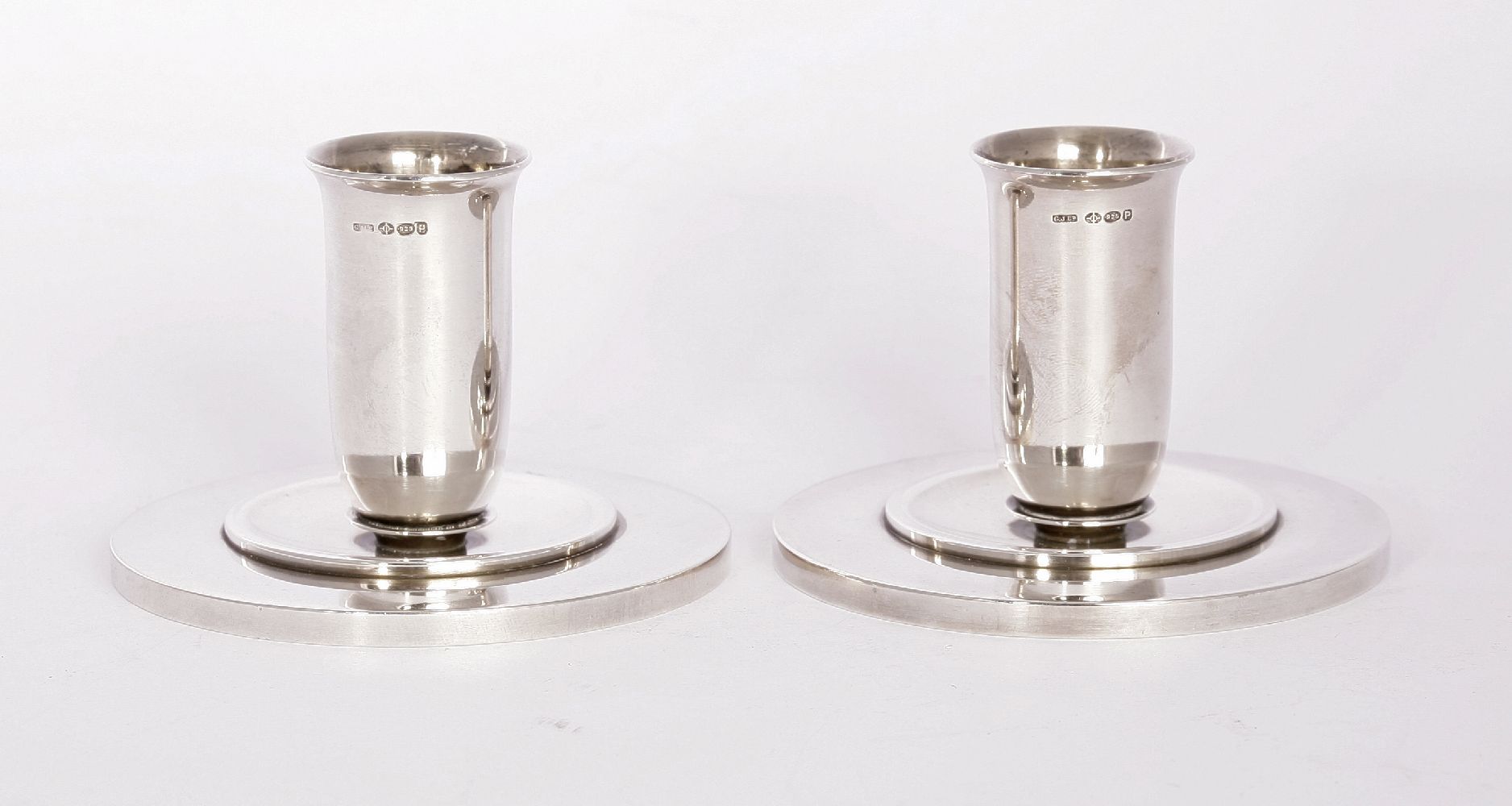 A pair of Georg Jensen silver candlesticks,with import marks for London 1950, designed by Harald