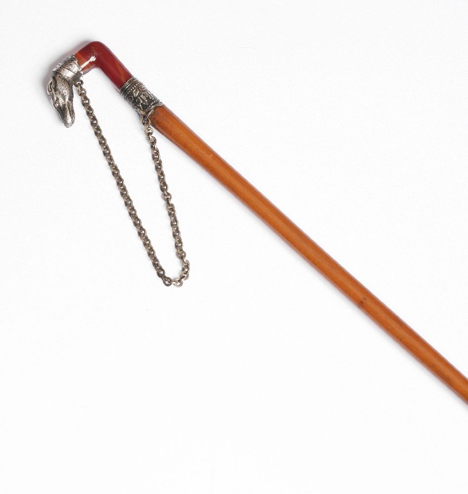 A silver-mounted lady`s riding stick, the cornelian handle with silver mount modelled as a