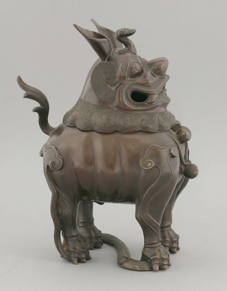 A bronze incense burner, 19th century, formed as a Buddhist lion with ruyi crest, hinging on the - Image 2 of 4