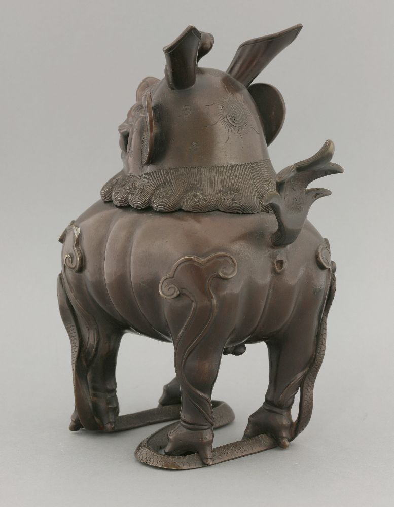 A bronze incense burner, 19th century, formed as a Buddhist lion with ruyi crest, hinging on the - Image 3 of 4