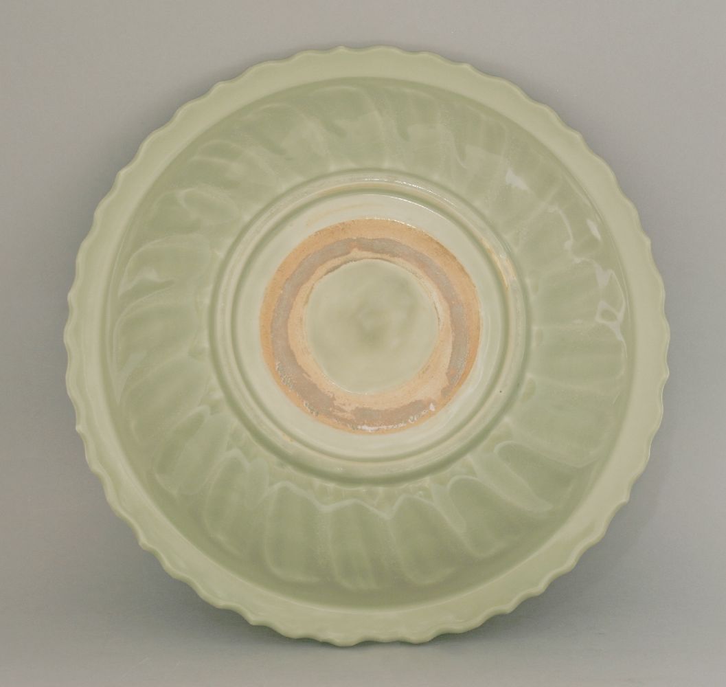 A Ming celadon Bowl,  early 15th century, with barbed rim, the centre impressed with a peony - Image 2 of 2