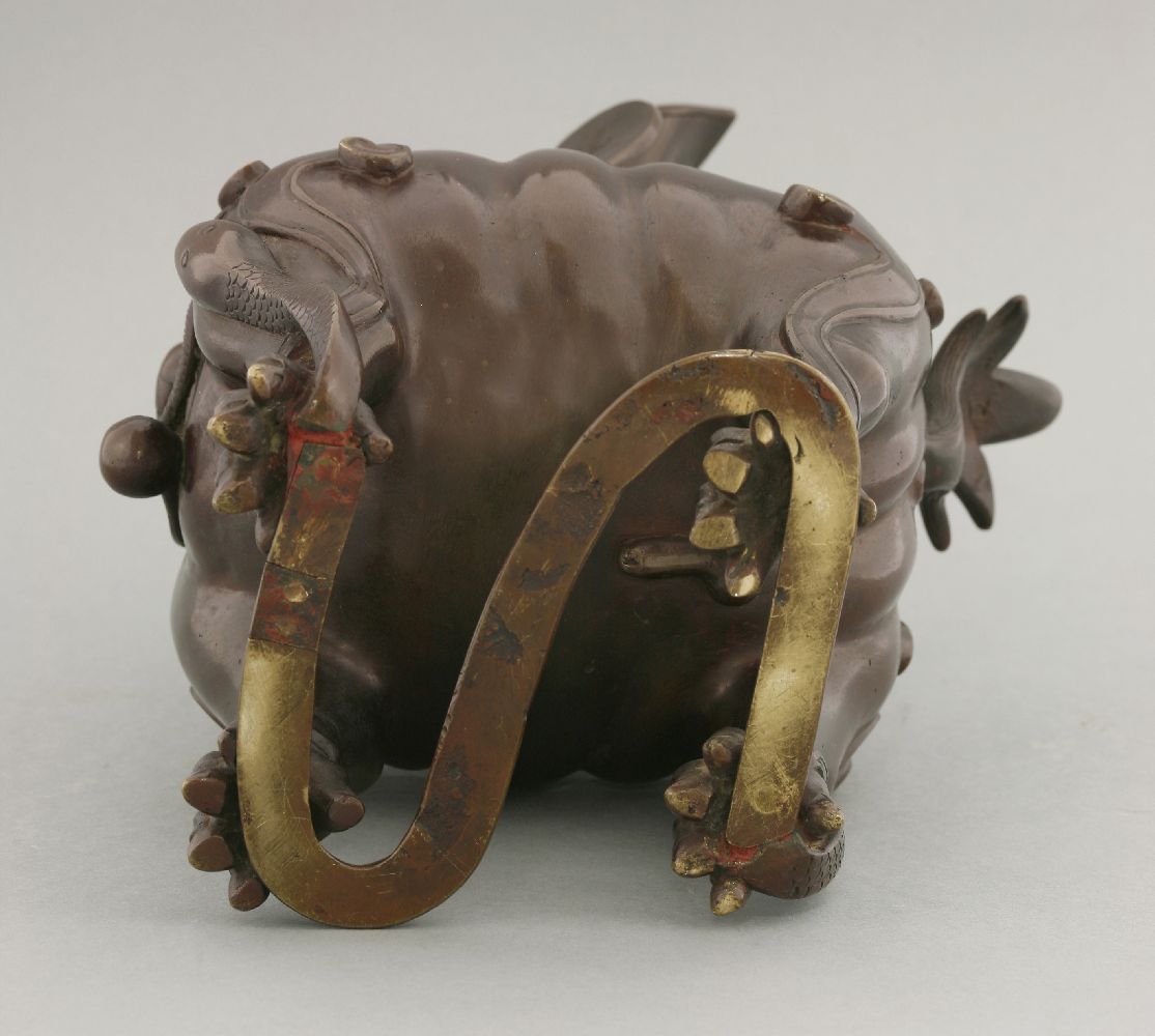 A bronze incense burner, 19th century, formed as a Buddhist lion with ruyi crest, hinging on the - Image 4 of 4