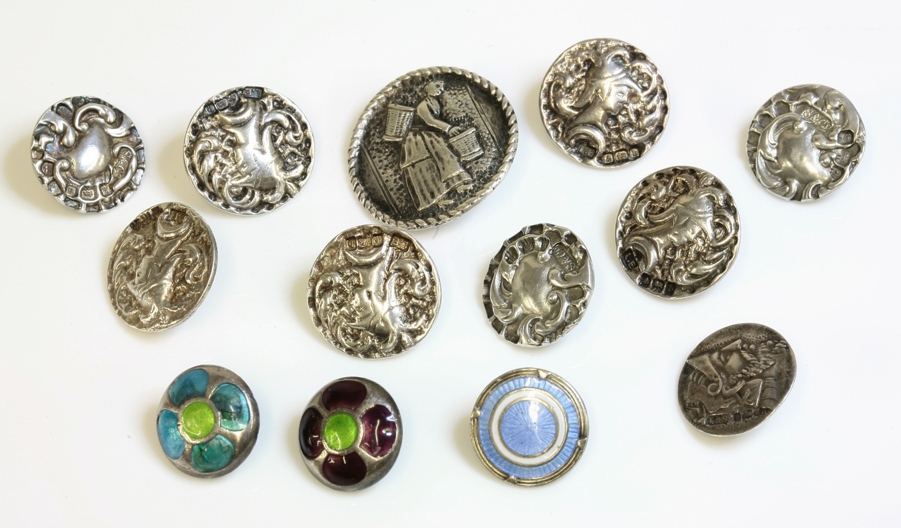 A set of five sterling silver Art Nouveau buttons,
by Lawrence Emanuel, Birmingham 1901, depicting a