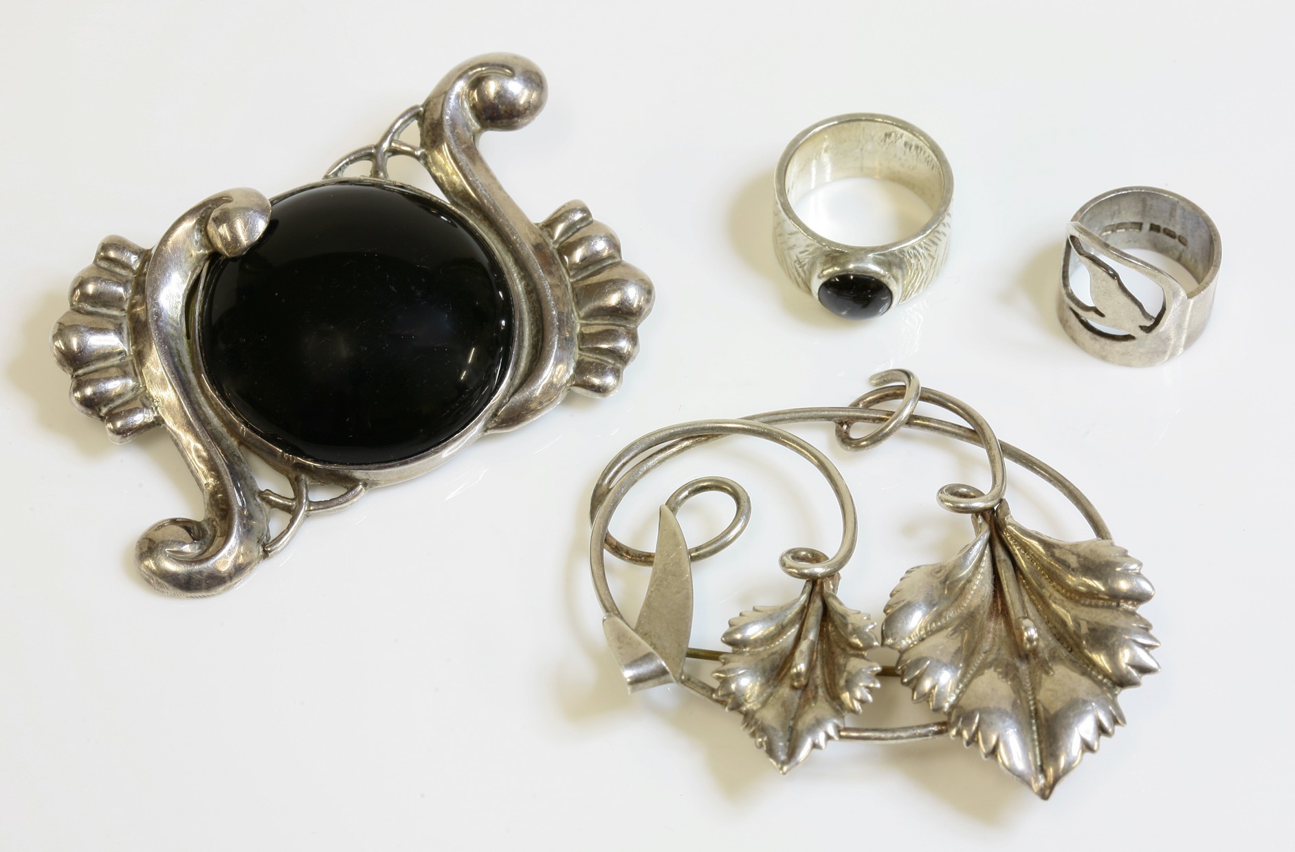 A Mexican silver and onyx brooch,
by Fred Davis, possibly c.1940, with a central circular cabochon