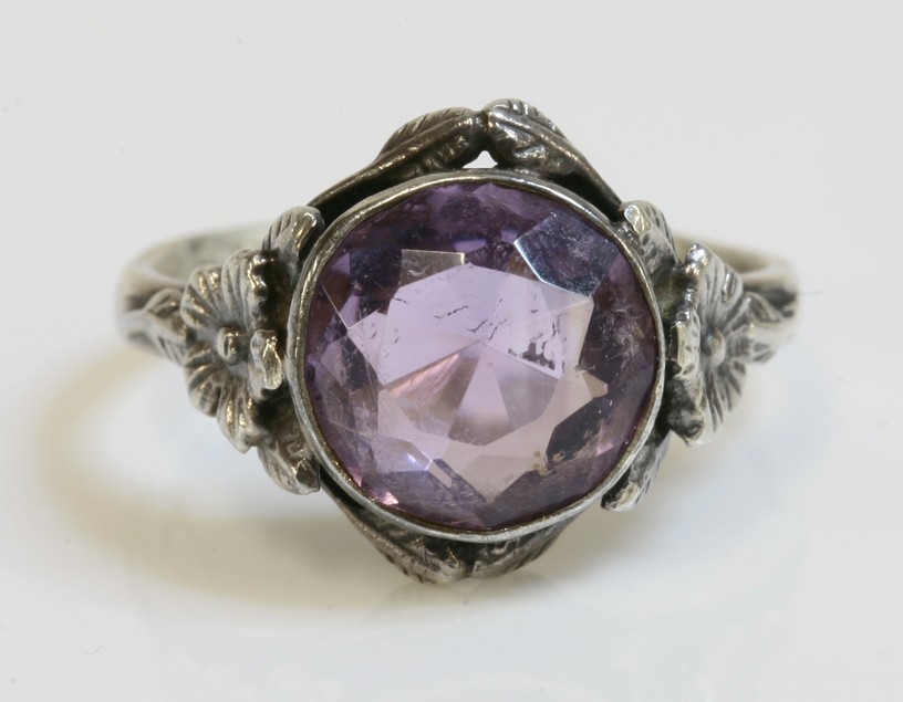 An Arts and Crafts silver single stone amethyst ring,
attributed to Bernard Instone, a circular