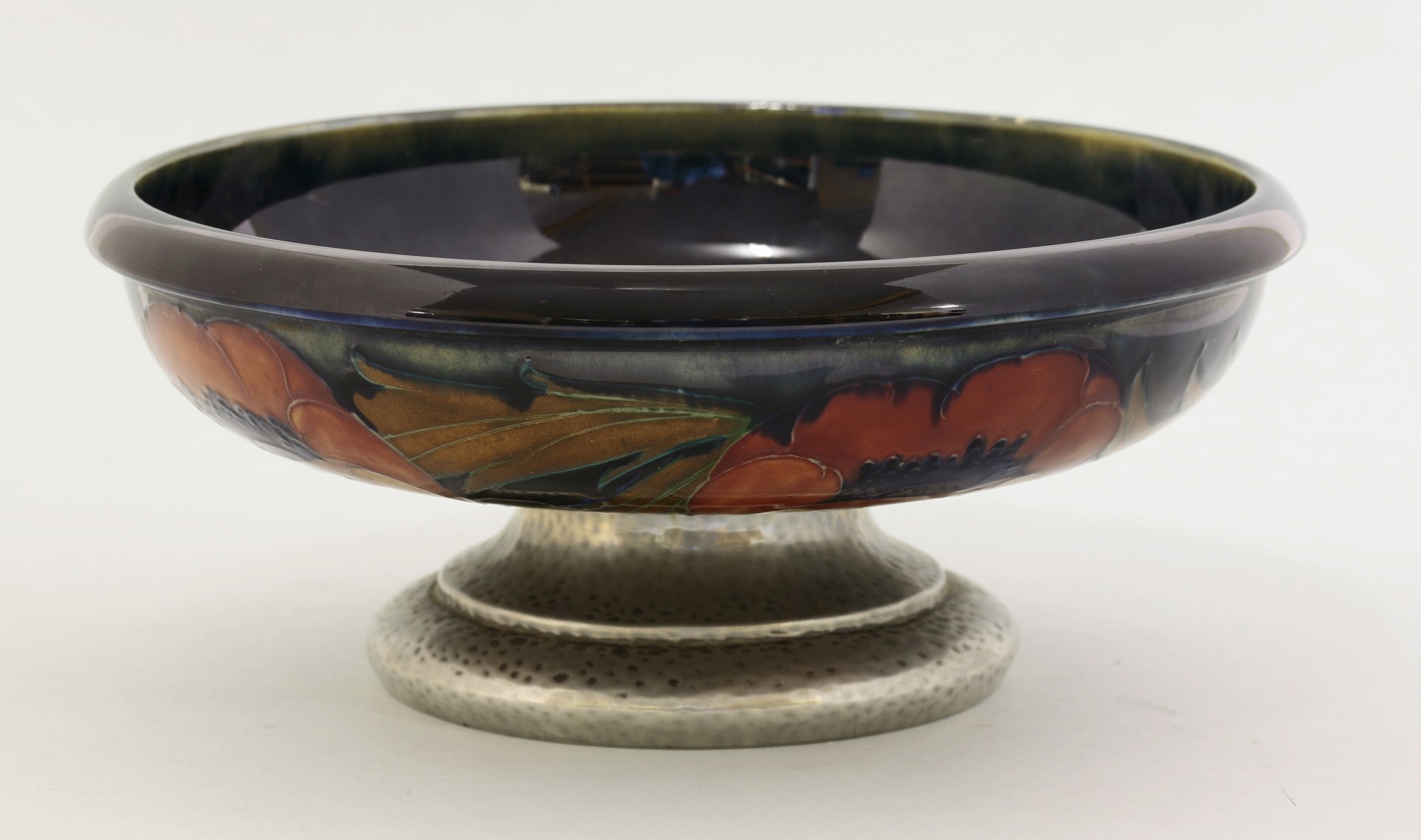 A Tudric Moorcroft 'Poppy' bowl,
mounted on a Tudric pewter foot, stamped 'Made In England Tudric