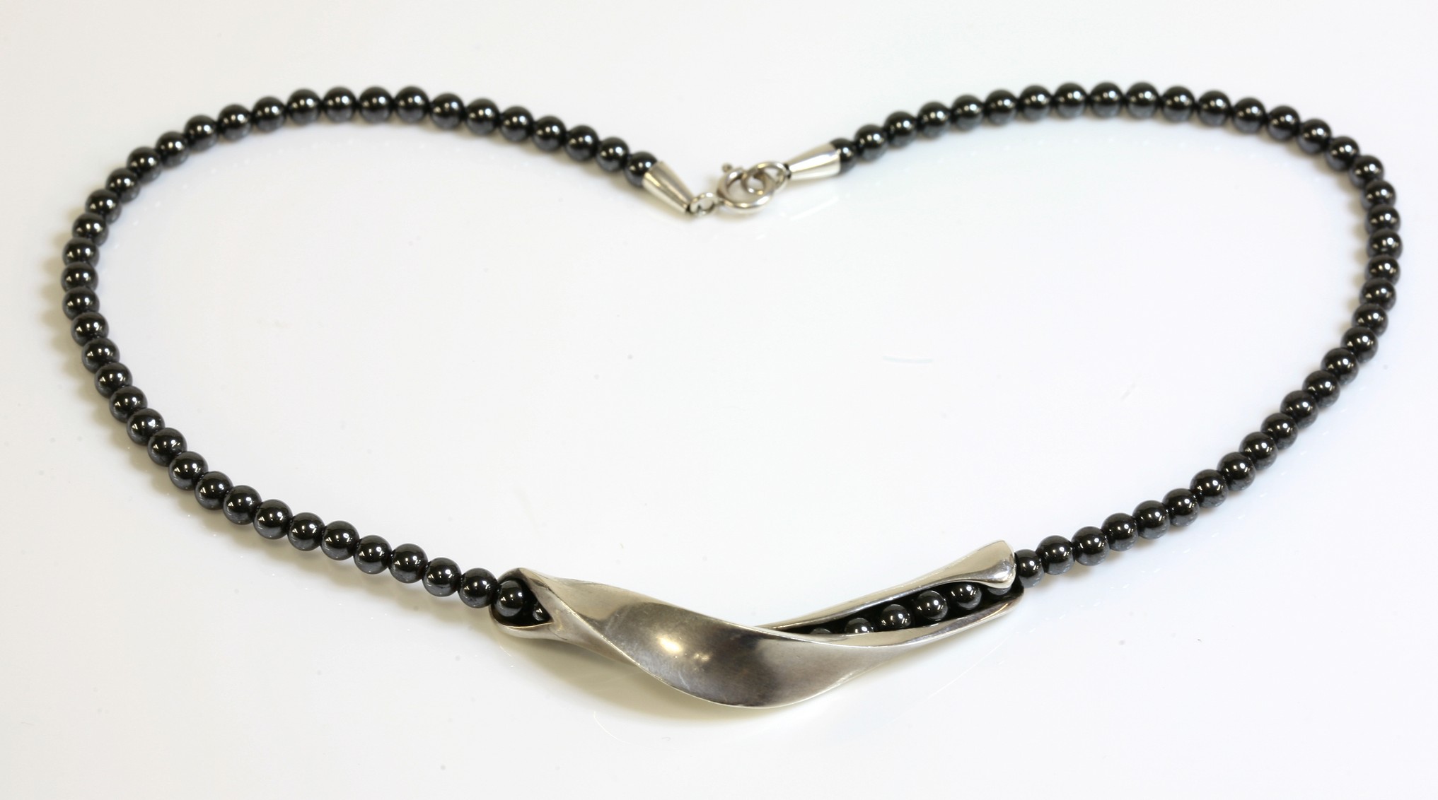 A cased silver 'Moonlight' haematite bead necklace by Georg Jensen, not numbered, a row of 4.4mm