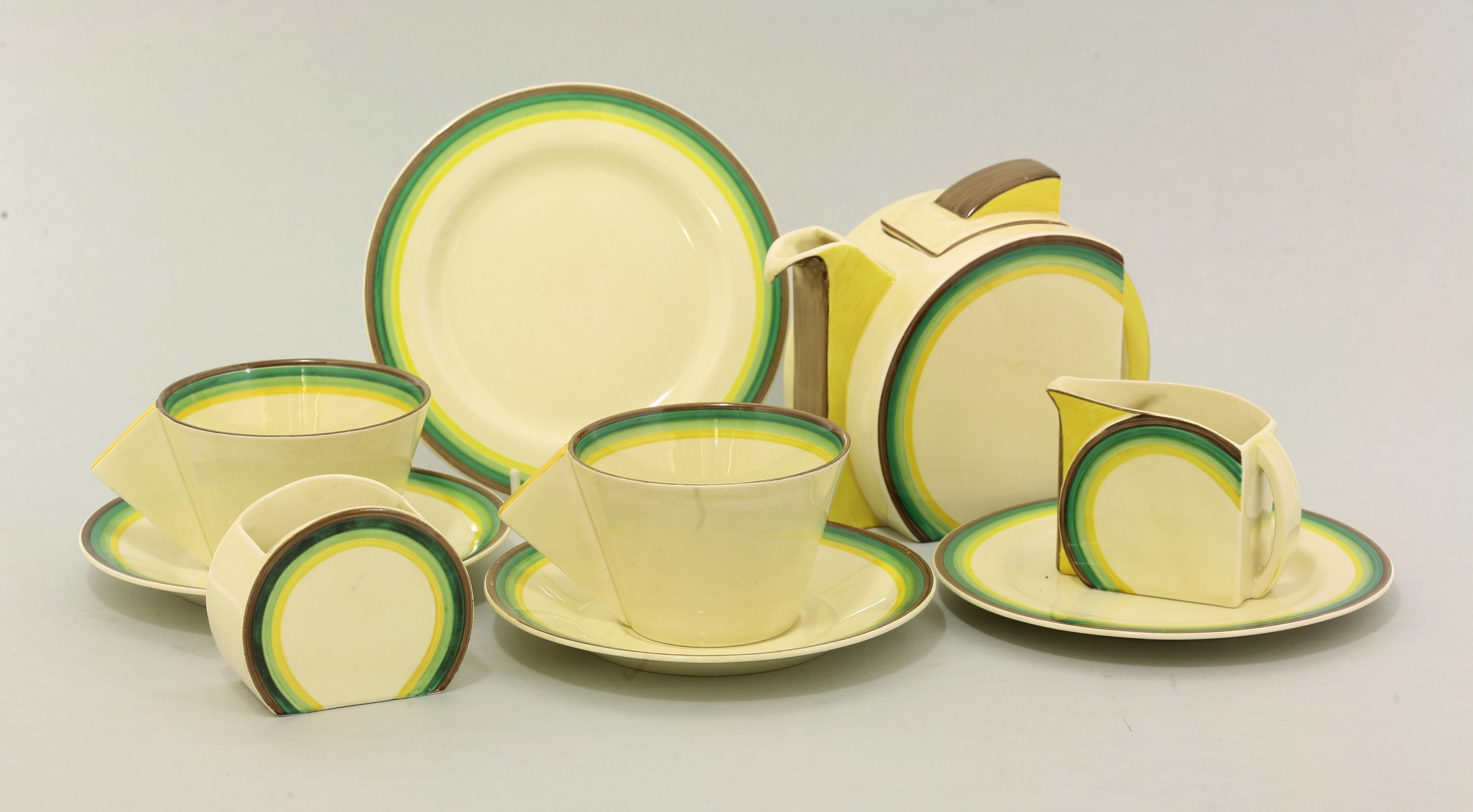 A Clarice Cliff Stamford breakfast set,
decorated with bands of brown, green and yellow,