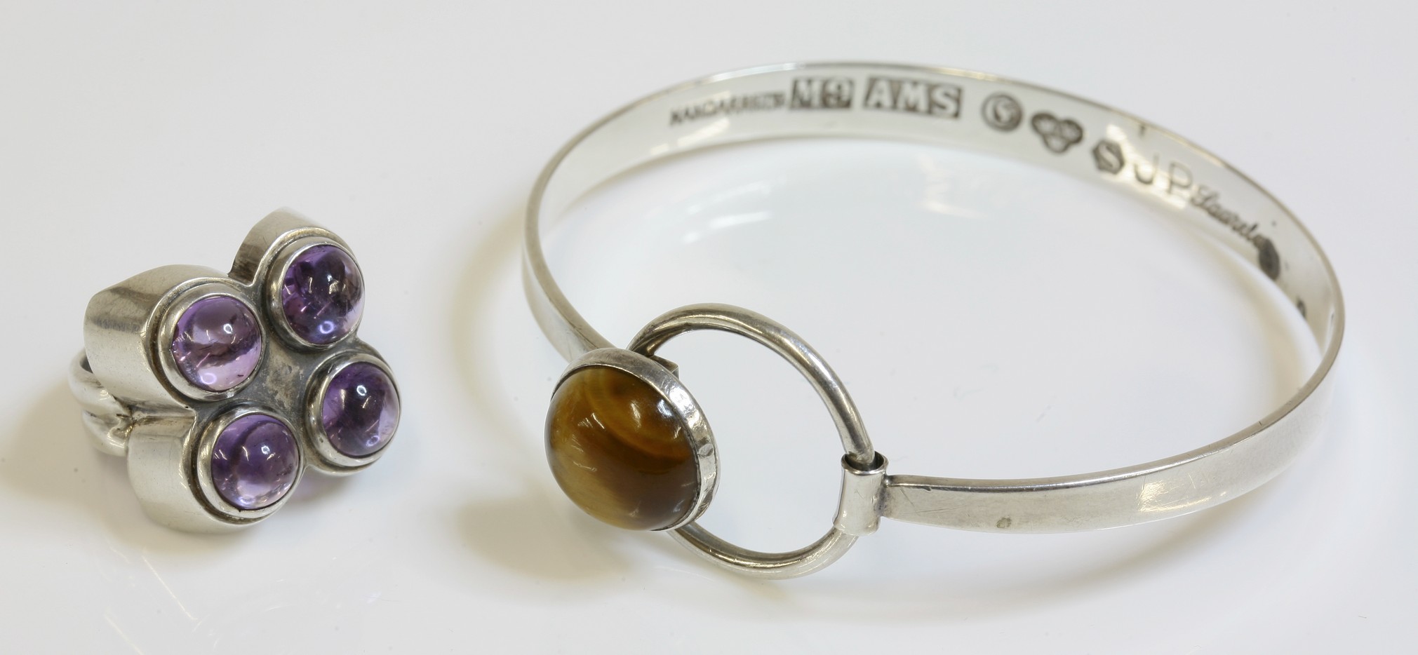 A Swedish silver tiger's eye bangle, c.1960,
by Arvo Saarela, with a circular rub set tiger's eye