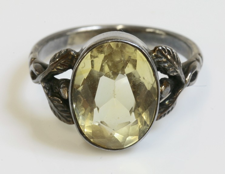 An Arts and Crafts silver single stone citrine ring,
attributed to Bernard Instone, an oval mixed