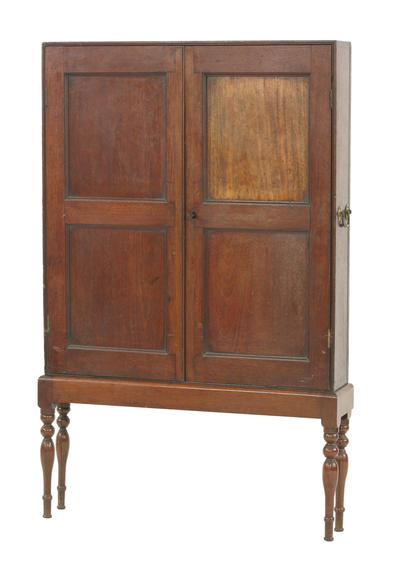 A mahogany campaign medicine cabinet,
with panelled cupboard doors, enclosing five shelves raised on