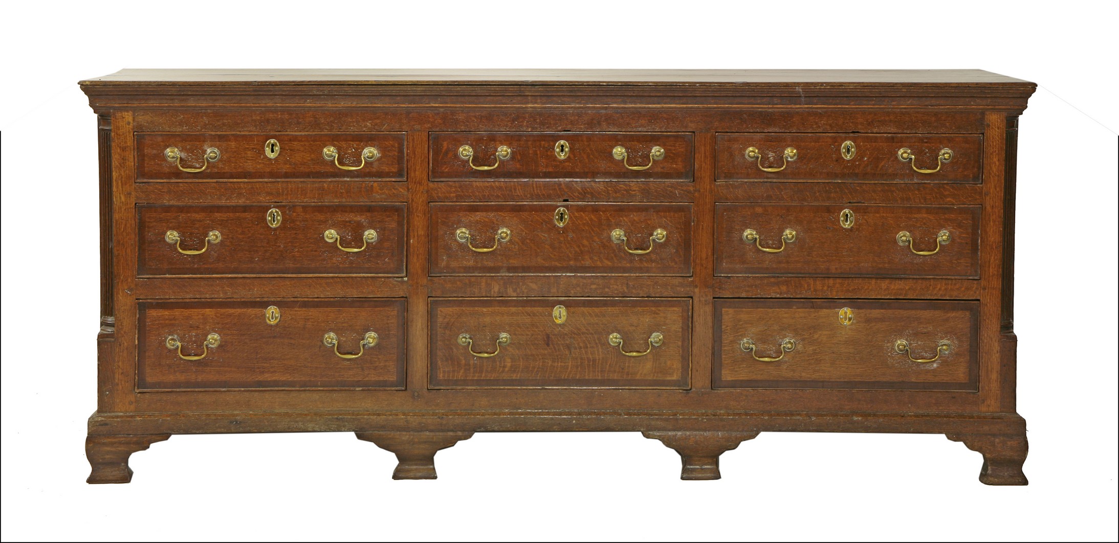 A George III oak Lancashire chest,
with an arrangement of nine drawers, with mahogany