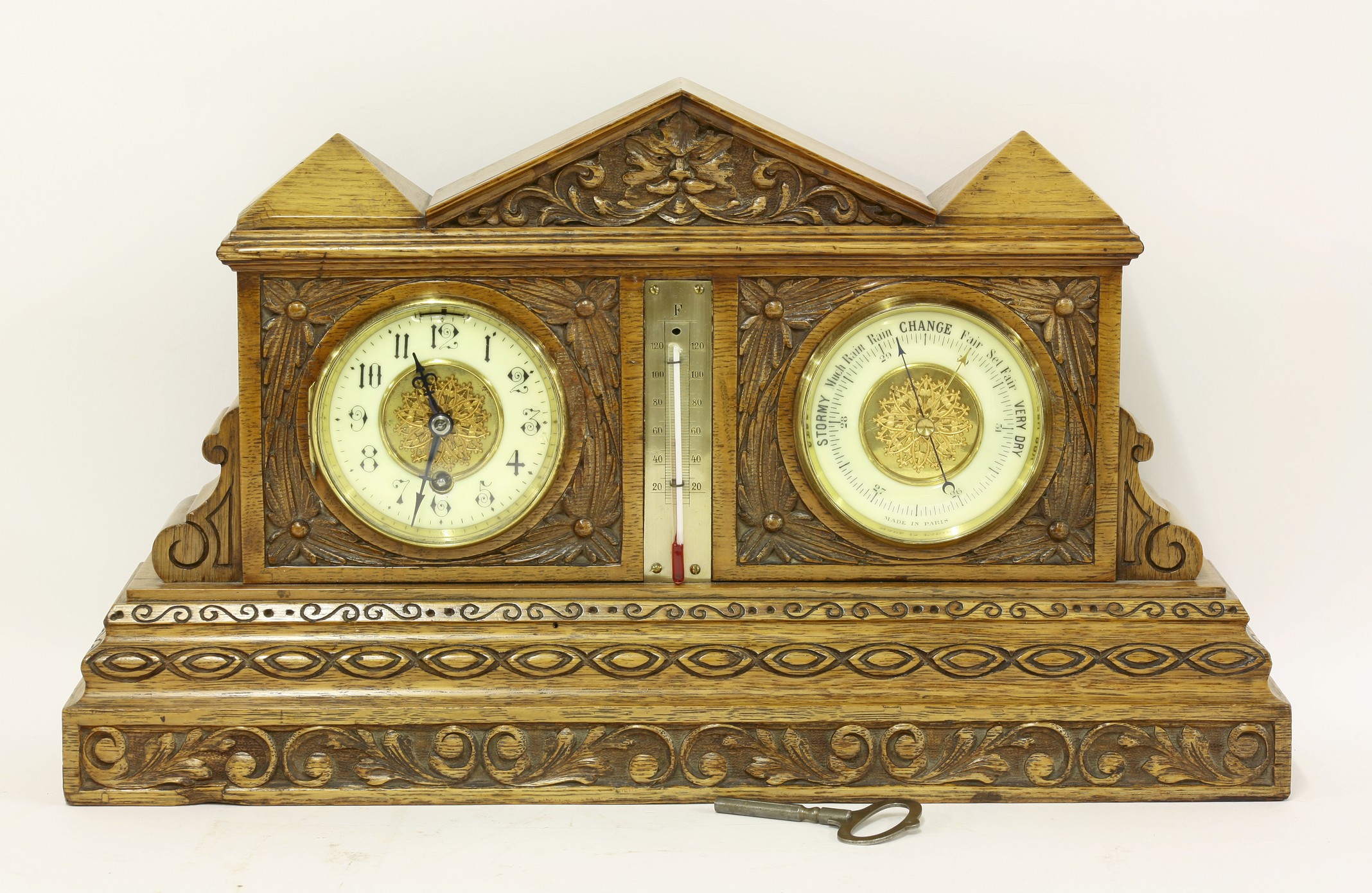 A late Victorian carved oak clock and barometer set, in architectural form case, 46cm wide