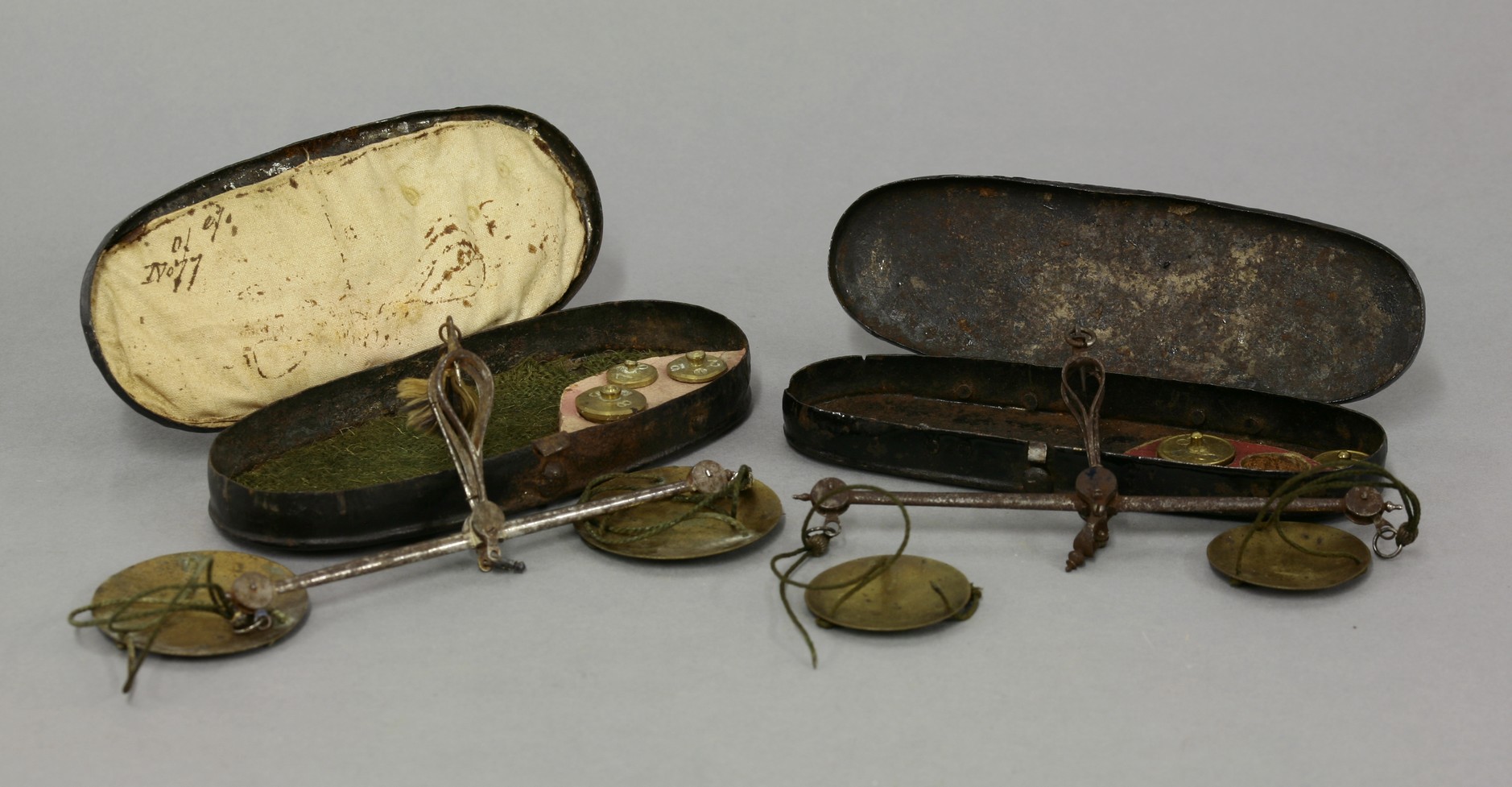 Two George III steel and brass coin scales, circa 1770, each beam with box ends, one housing three