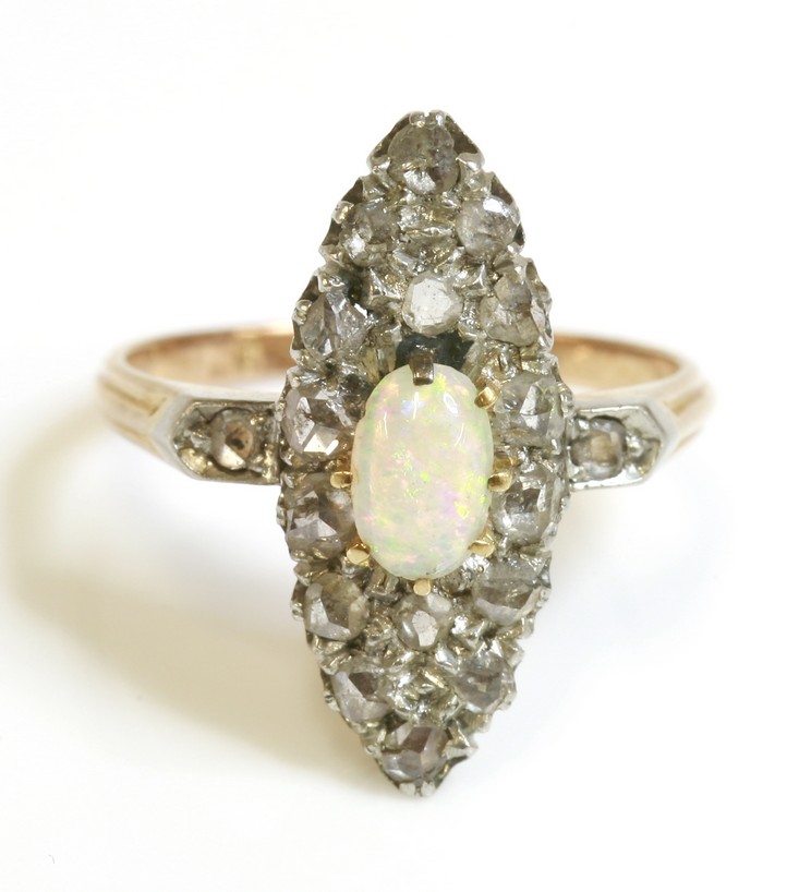 An Edwardian opal and diamond marquise shaped cluster ring, with diamond set shoulders, possibly