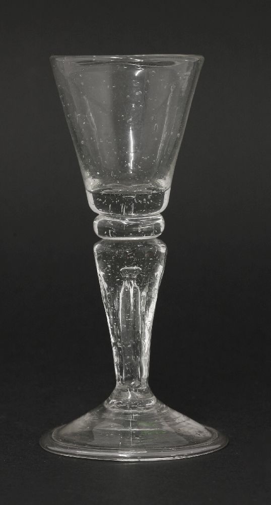 A soda metal Gin Glass,c.1730, having a conical bowl over a flattened knop, an hexagonal teared,