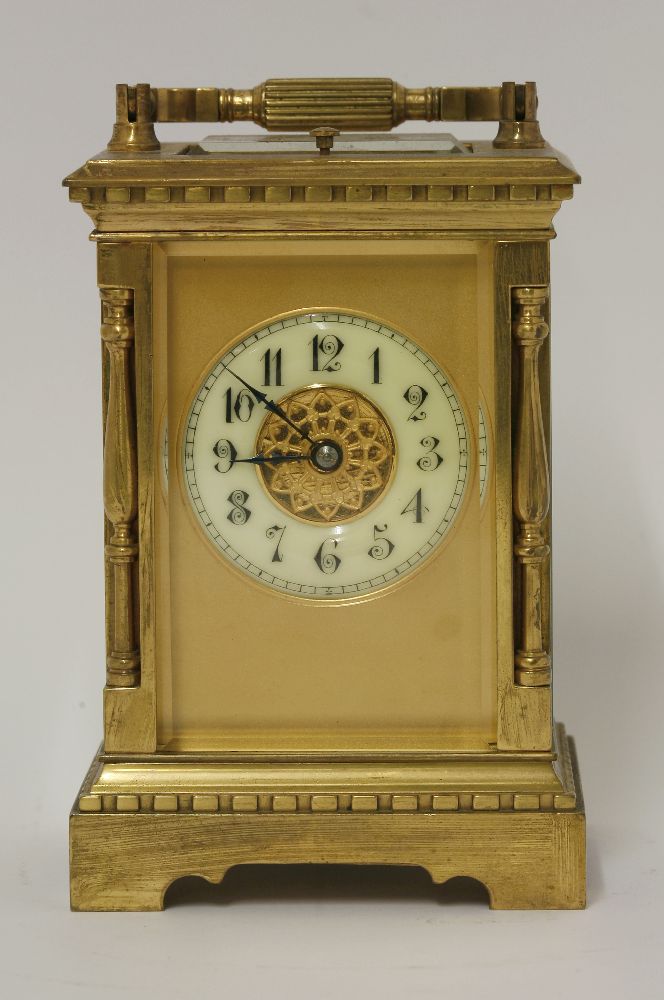 A 19th century brass corniche cased carriage clock, with repeating action and chiming on a gong
