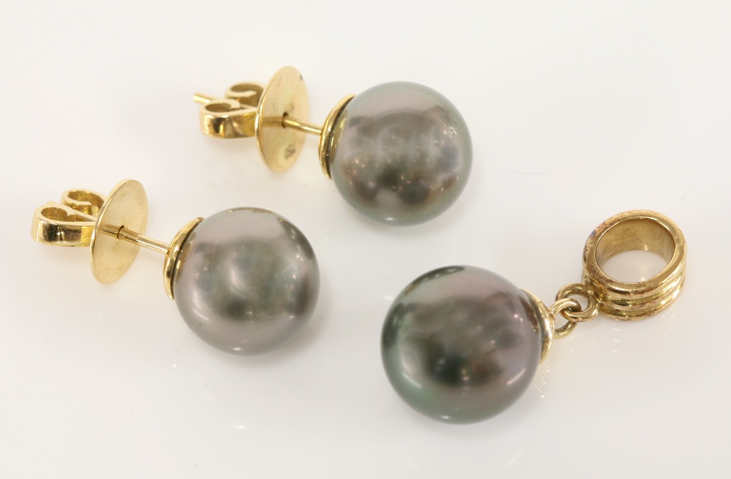 A pair of Tahitian cultured pearl stud earrings,
10.7mm diameter, cup and peg set to post and