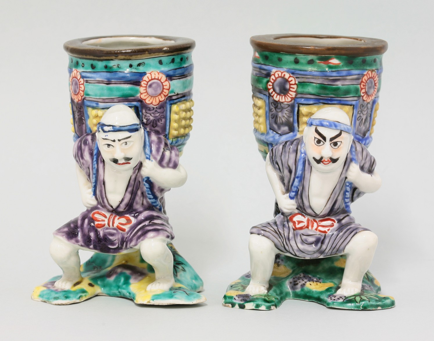 A pair of Kutani Vases,
late 19th century, each in the form of Benkei, a massive temple bell on