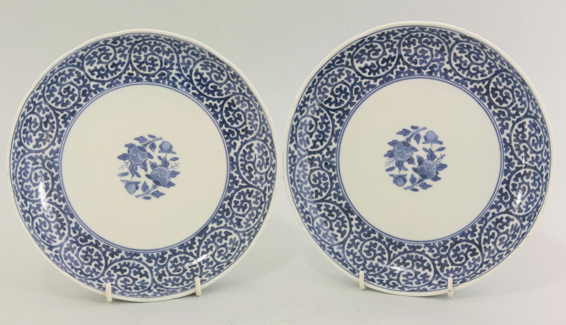 A pair of Arita blue and white Plates,
c.1750, each with karakusa borders enclosing flowers,