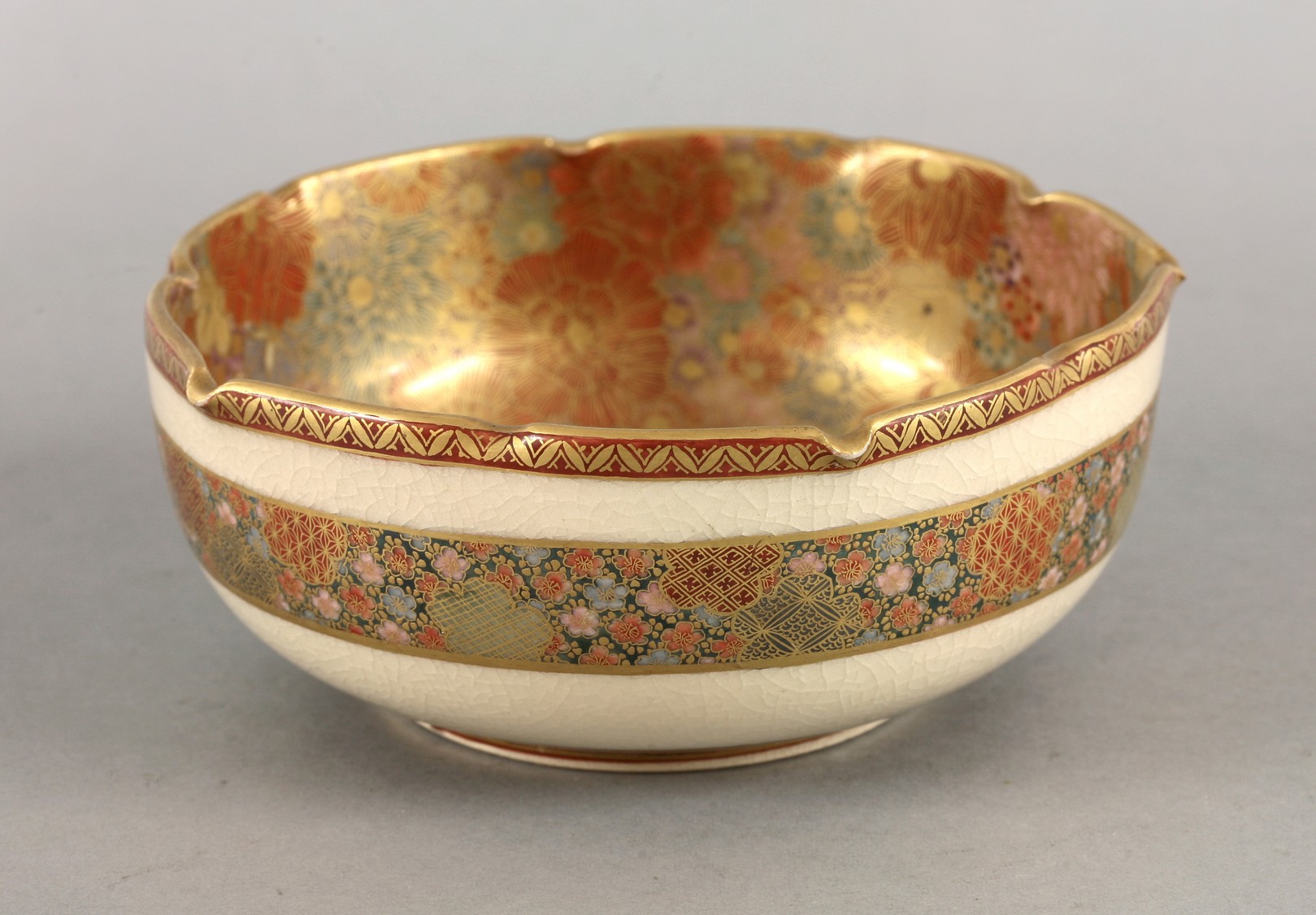 A 'Satsuma' Bowl,
c.1900, with notched rim enclosing enamelled and gilt millefleurs, the exterior