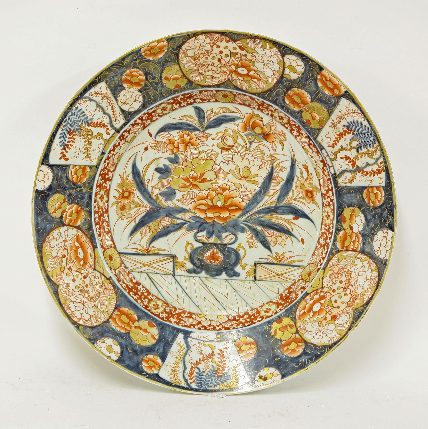 A large Arita Dish,
c.1690, painted in the Imari palette, with a jardinière of peony within a border