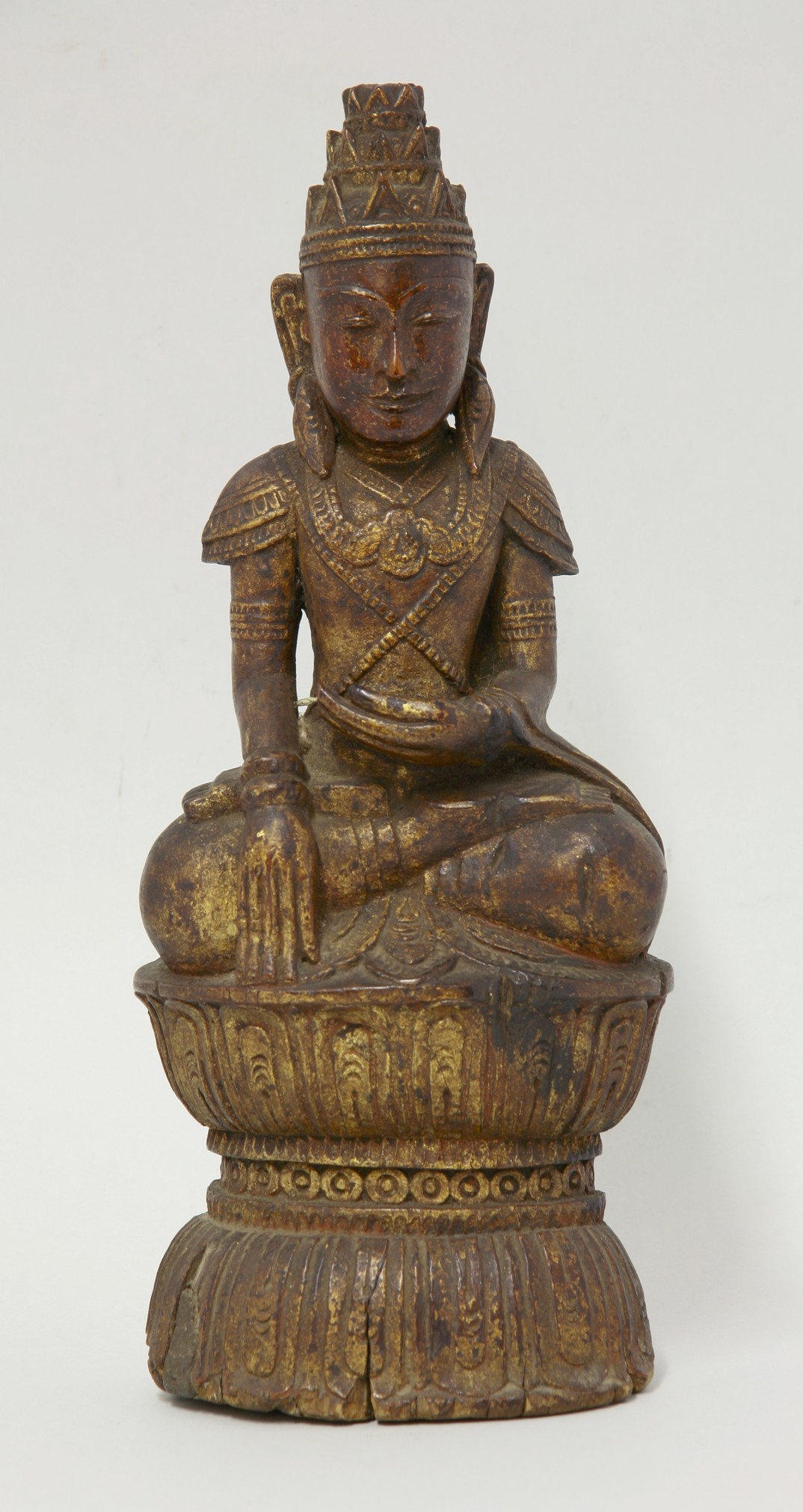 A carved and gilded wood Bodhisattva, 19th century or later, seated upon a lotus, 34.5cm