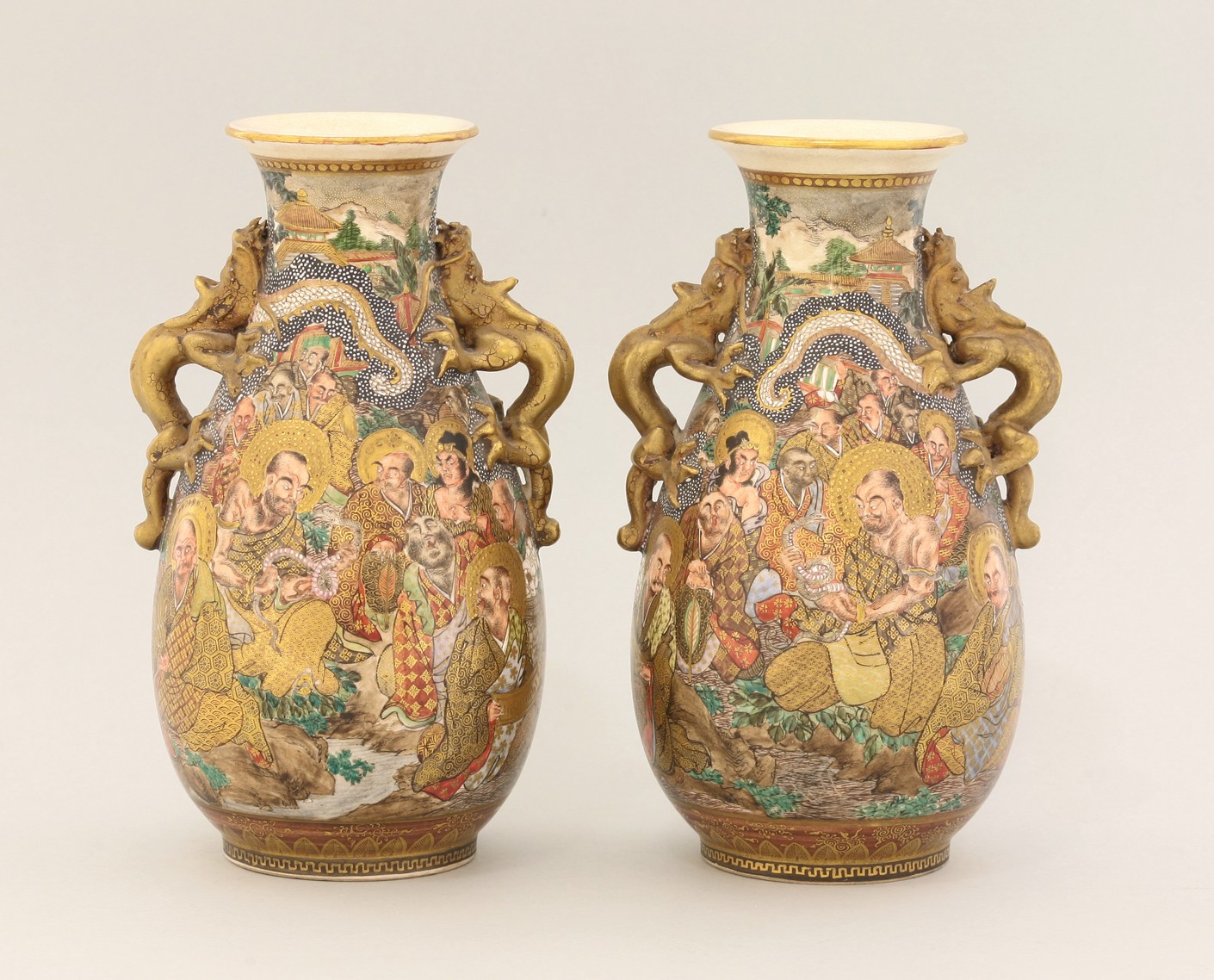 A pair of 'Satsuma' Vases,
c.1880, each of pear shape, painted with Kwannon and a Rakan, the sides