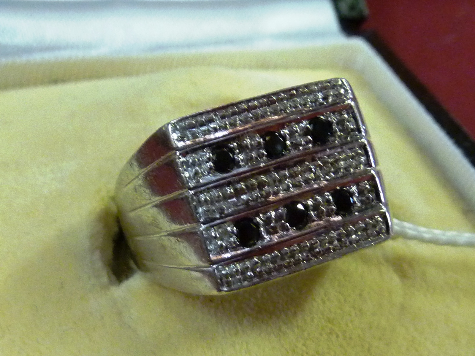 A gentleman`s heavy 9 carat white gold Ring set with six black diamonds