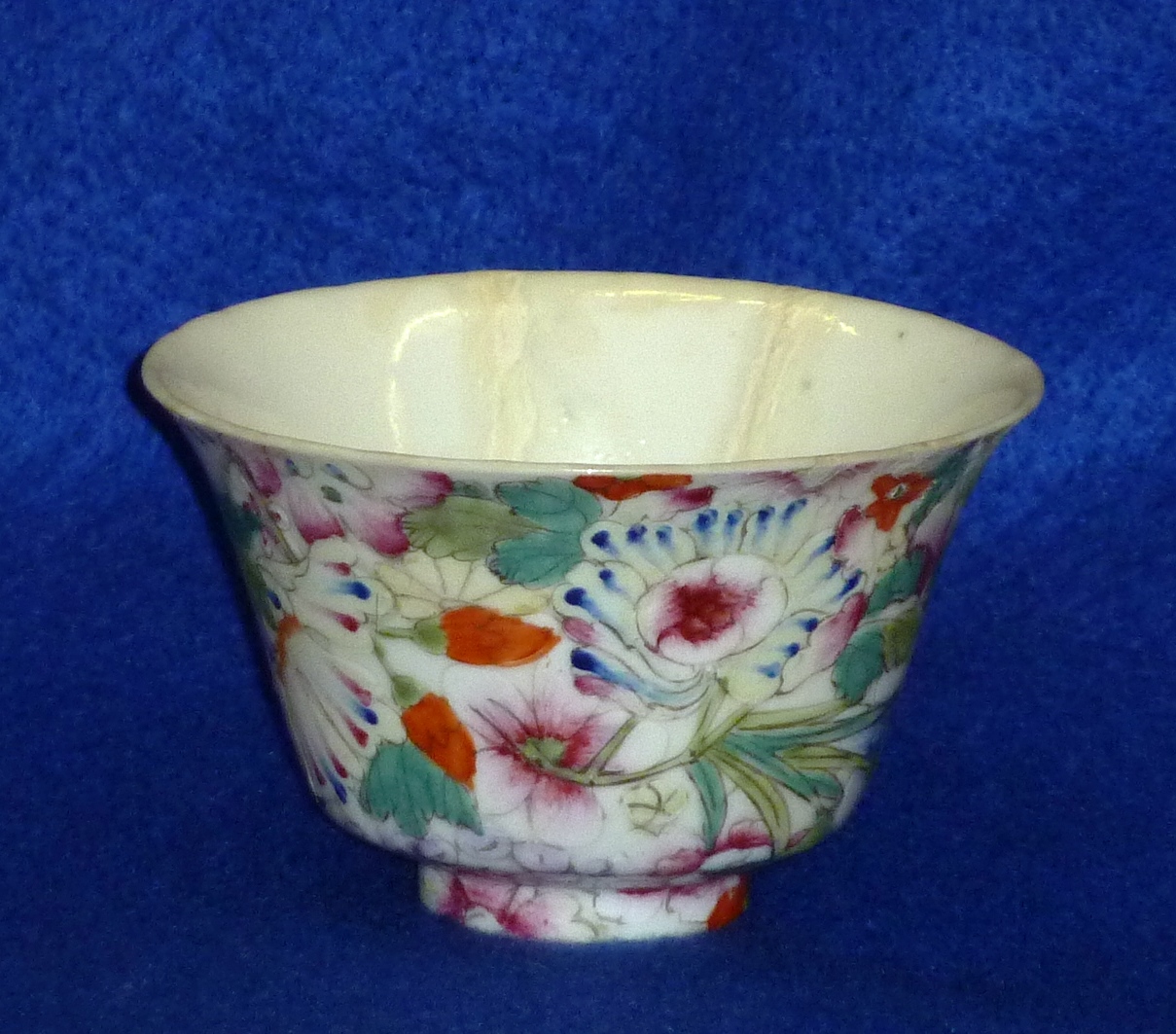 A late 19th/early 20th Century Chinese porcelain Wine Cup hand decorated in enamels with various