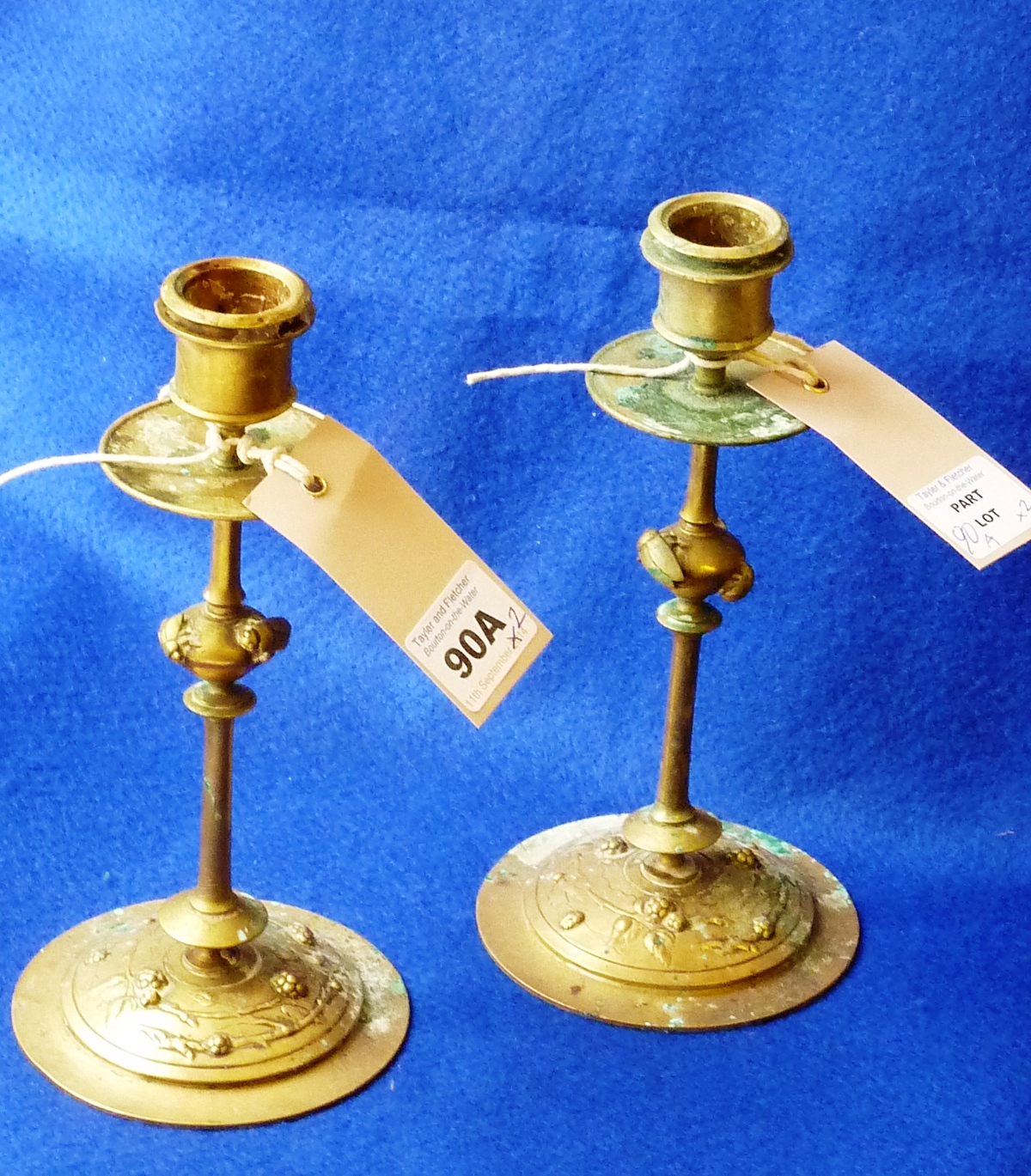 A pair of late 19th/early 20th Century gilt metal Candlesticks the central knops unusually